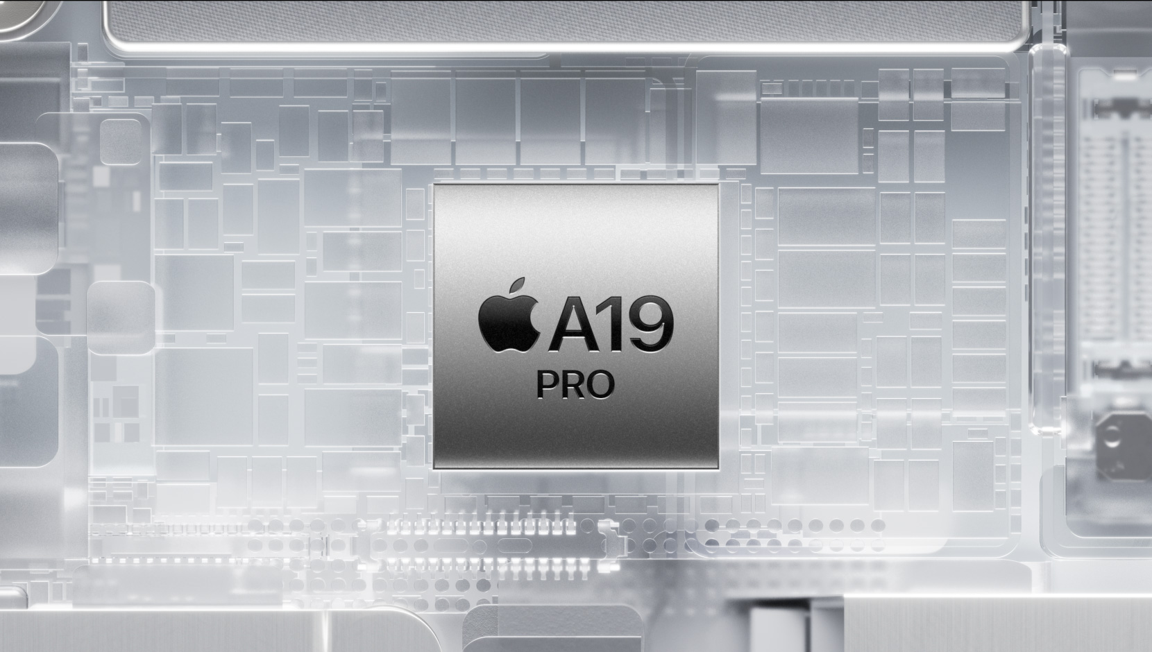 Čip A19 Pro vsazený mezi zářící vnitřní součásti iPhonu