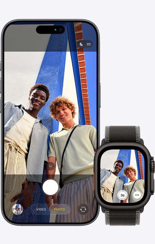 iPhone 17 elölnézetből, a kamerája csoportszelfit készít, mellette egy Apple Watch Ultra 3, amin a Kamera-távirányító app van megnyitva