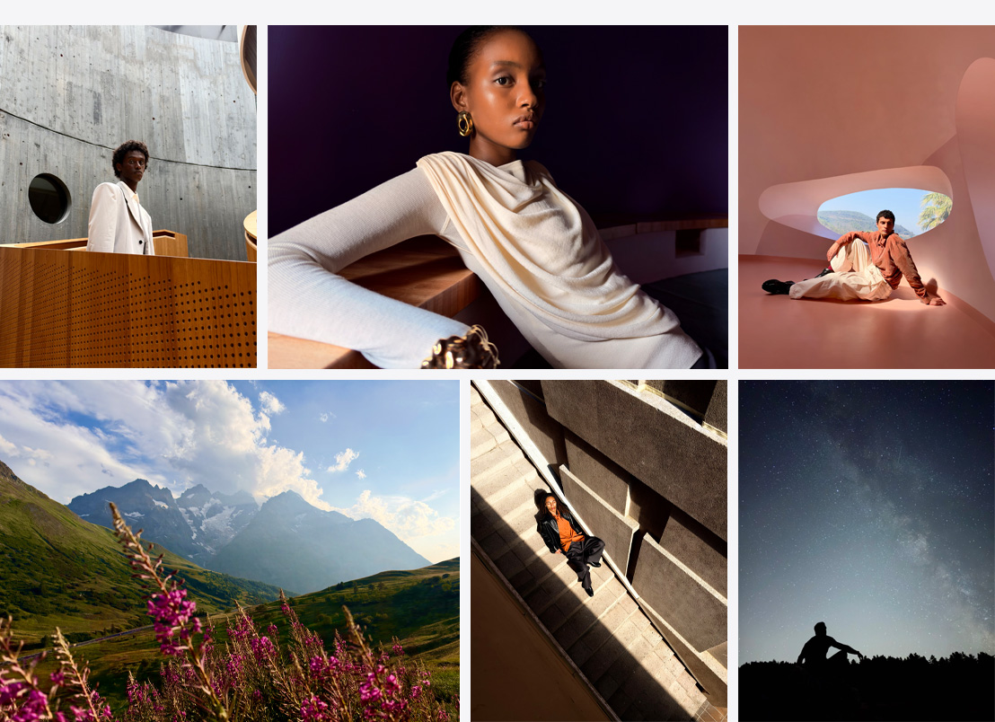 Series of iPhone photos, a person in a white jacket standing against a concrete wall, a close up of a woman leaning against a table with a shadow-filled room in the background, wide-angle shot of a person posing against a modern, colorful, architectural background, wide-angle shot of grassy mountains with purple flowers in the foreground, a woman posing on a set of stairs with the sun shining on her, a wide-angle shot of a starry night sky