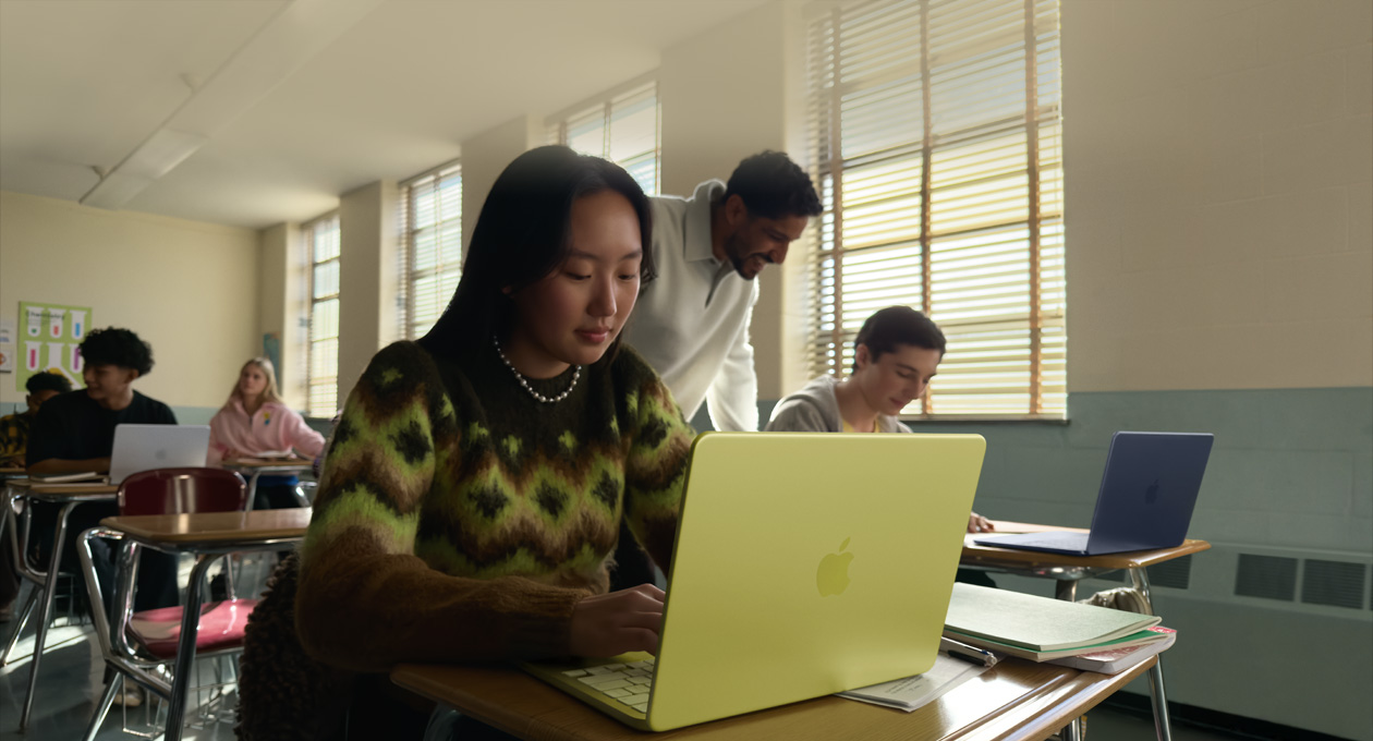 A student uses MacBook Neo, citrus color, unplugged in a classroom setting 