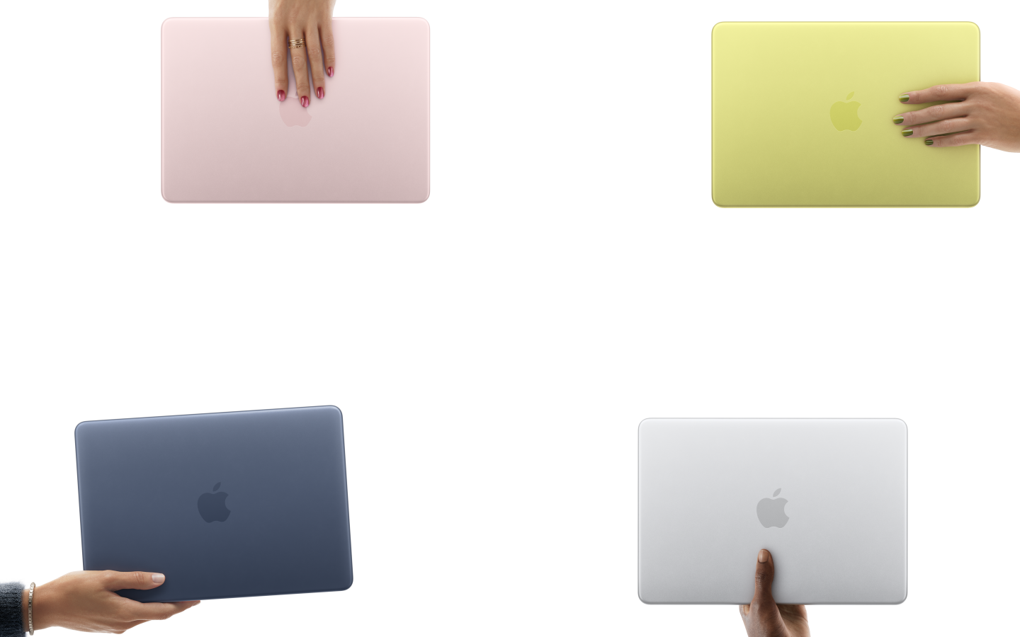 MacBook Neo laptops in various colors, each held in a different person's hand