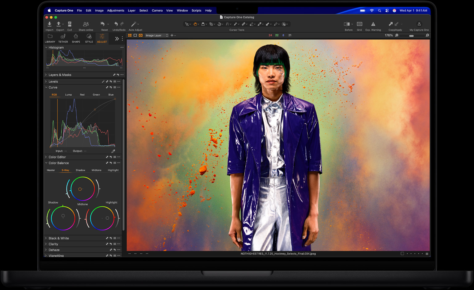 MacBook Pro screen of a photo of a person being edited in Capture One