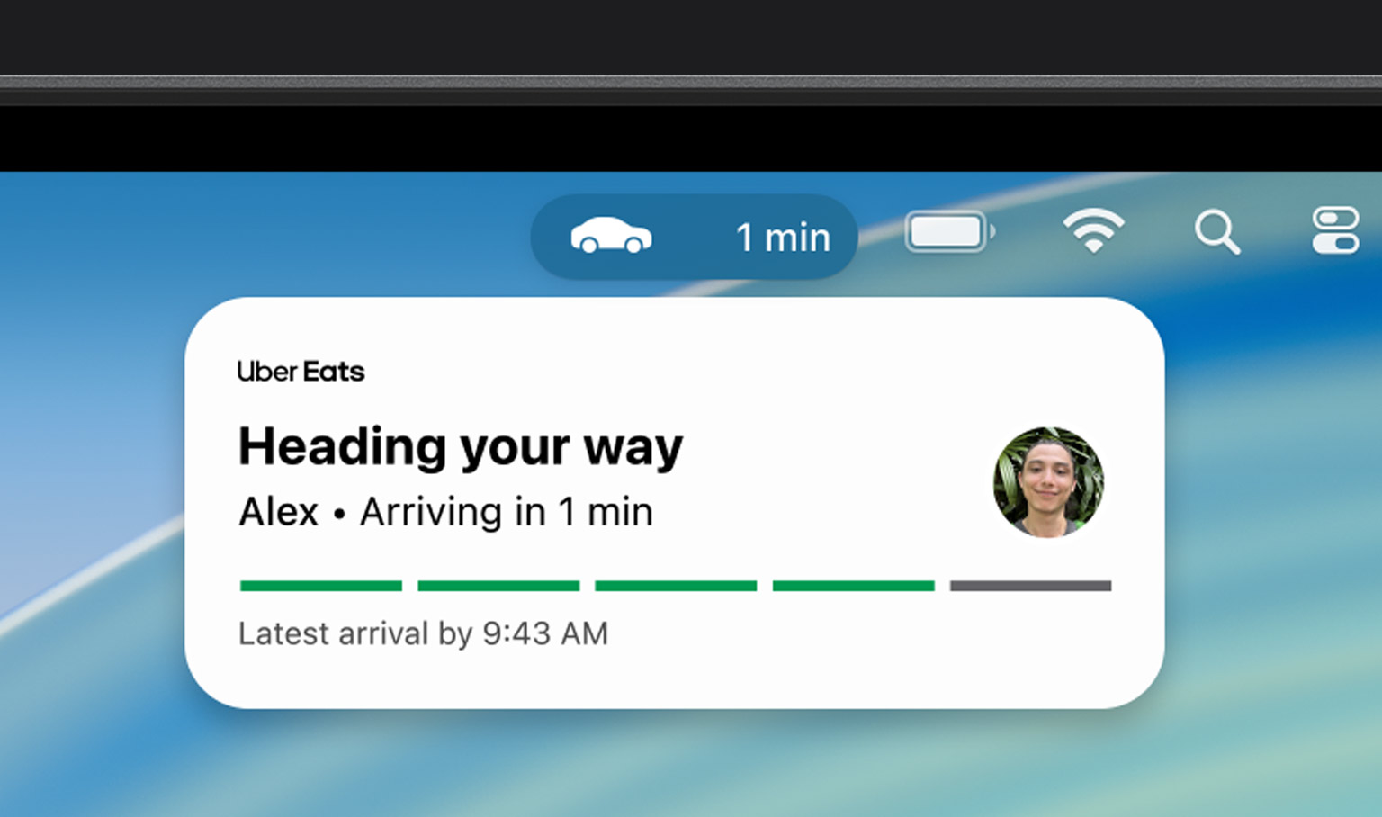 MacBook Pro, Live Activity notification shows an Uber Eats is on the way