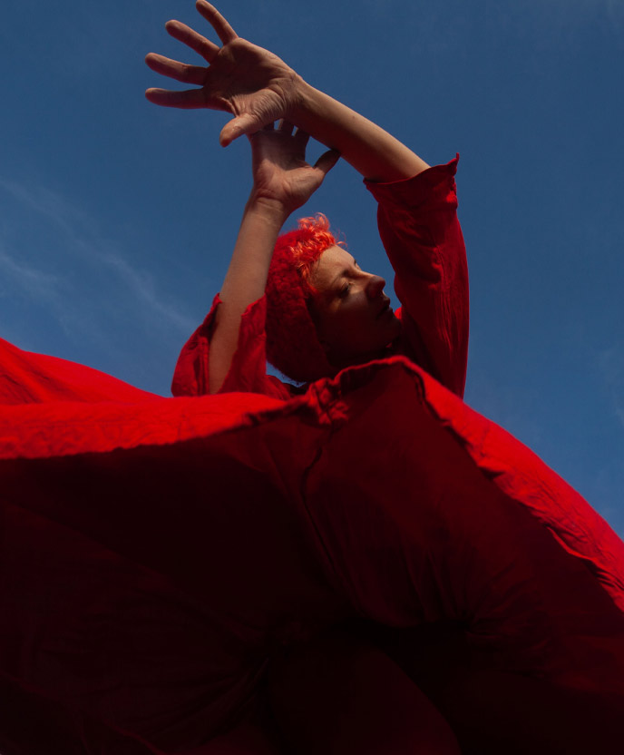 A person in a red dress dancing