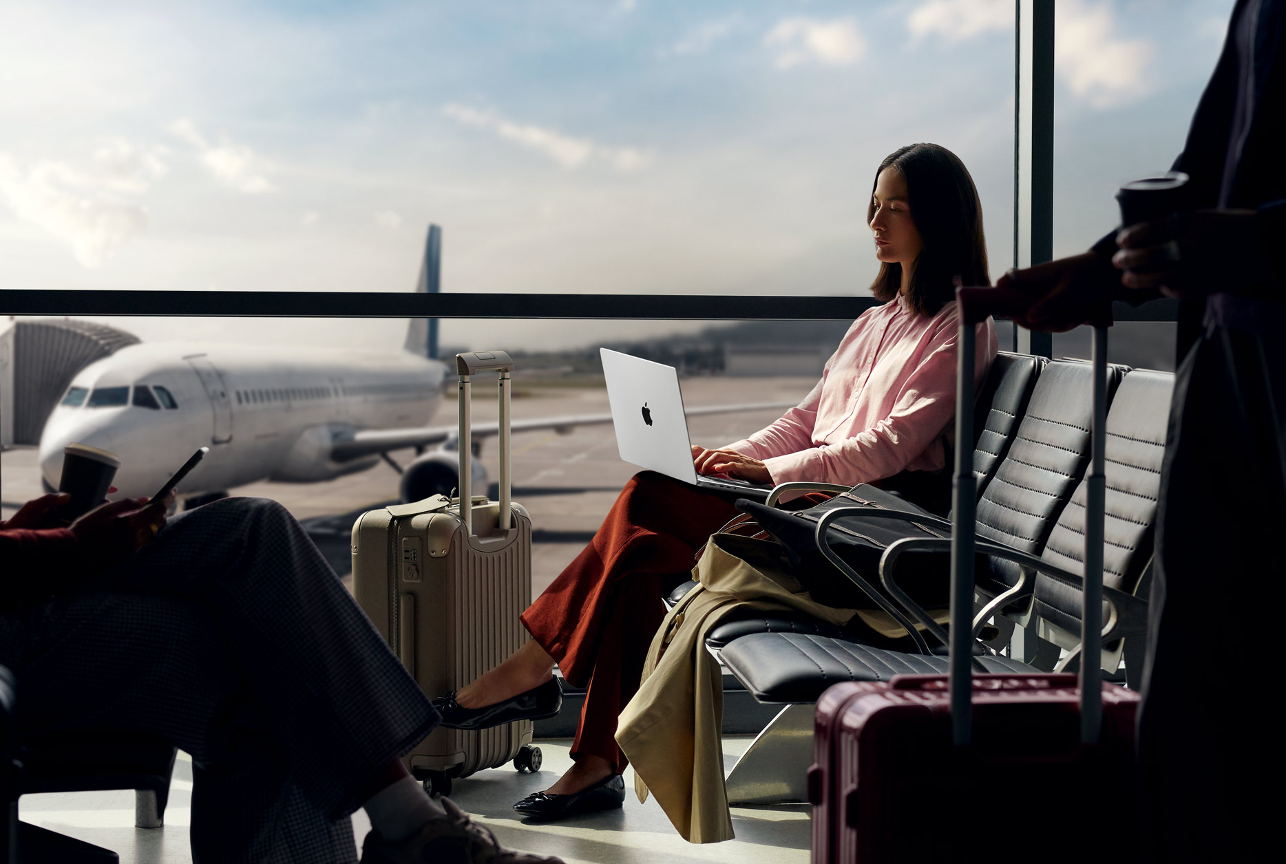 A person at an airport using their MacBook Pro