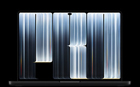 MacBook Pro with PROLED XDR Display, space black color, open, screen shows ribbon-like objects densely patterned with glowing stripes of various widths, spelling the word Pro