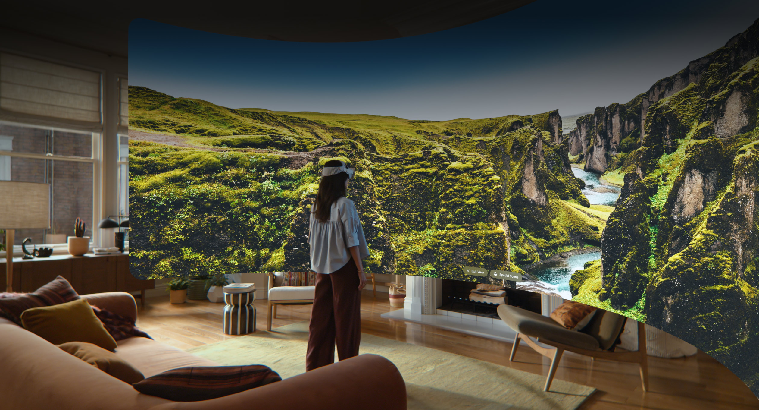 Apple Vision Pro view, a panoramic image of rocky green cliffs with a stream cutting through them and blue sky stretching beyond the cliffs
