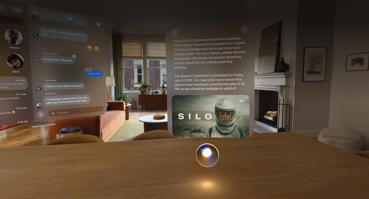 Apple Vision Pro being used in a living room, Messages conversation open to the left, Siri hovering over a bar counter in front of the user, a window above Siri shows a query and a response
