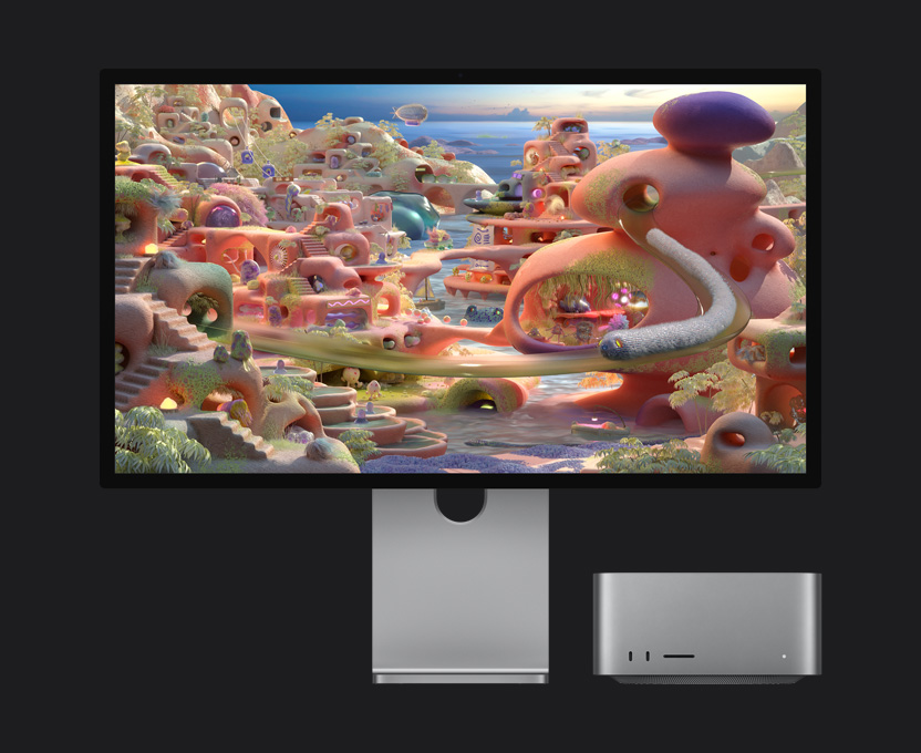 Een landschap in een animatiewereld op Studio Display XDR met eronder een Mac Studio, een wormachtig wezen komt uit een tunnel en beweegt over het scherm