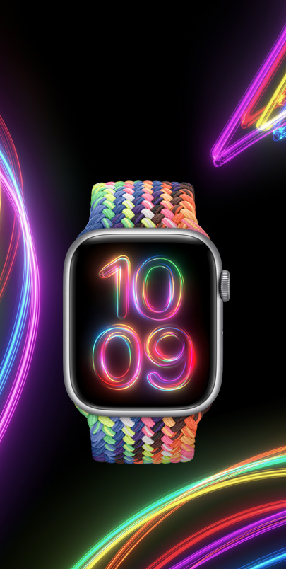 An Apple Watch Series 9 with the new neon multicoloured Pride Edition Braided Solo Loop and matching Pride Radiance watch face.